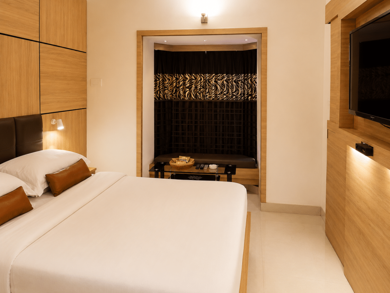 Premium room Kolkata with spacious bedroom and Bay window Seating at Roland Hotel